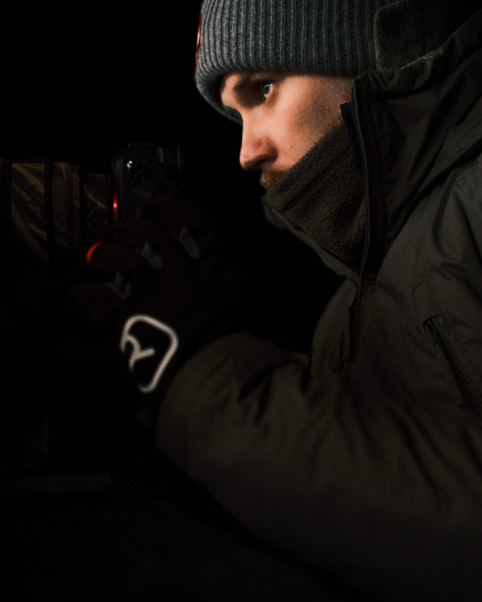 Portrait of Chris Schwaiger — Austrian wildlife photographer in the field with camera equipment